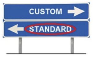 road signs with word "Custom" and an arrow pointing to the left, and below it a sign reading "Standard" and pointing to the right, word standard is circled in red