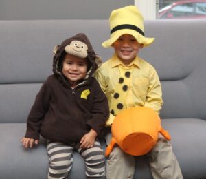 Partner Lina Bankert's kids as Curious George and the Man in the Yellow Hat