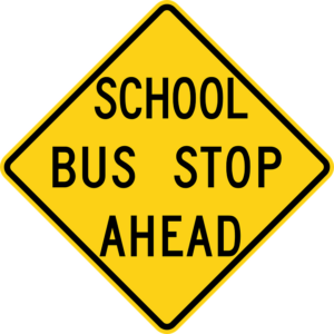 yellow sign reading "SCHOOL BUS STOP AHEAD"